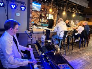 Piano player performing at bar